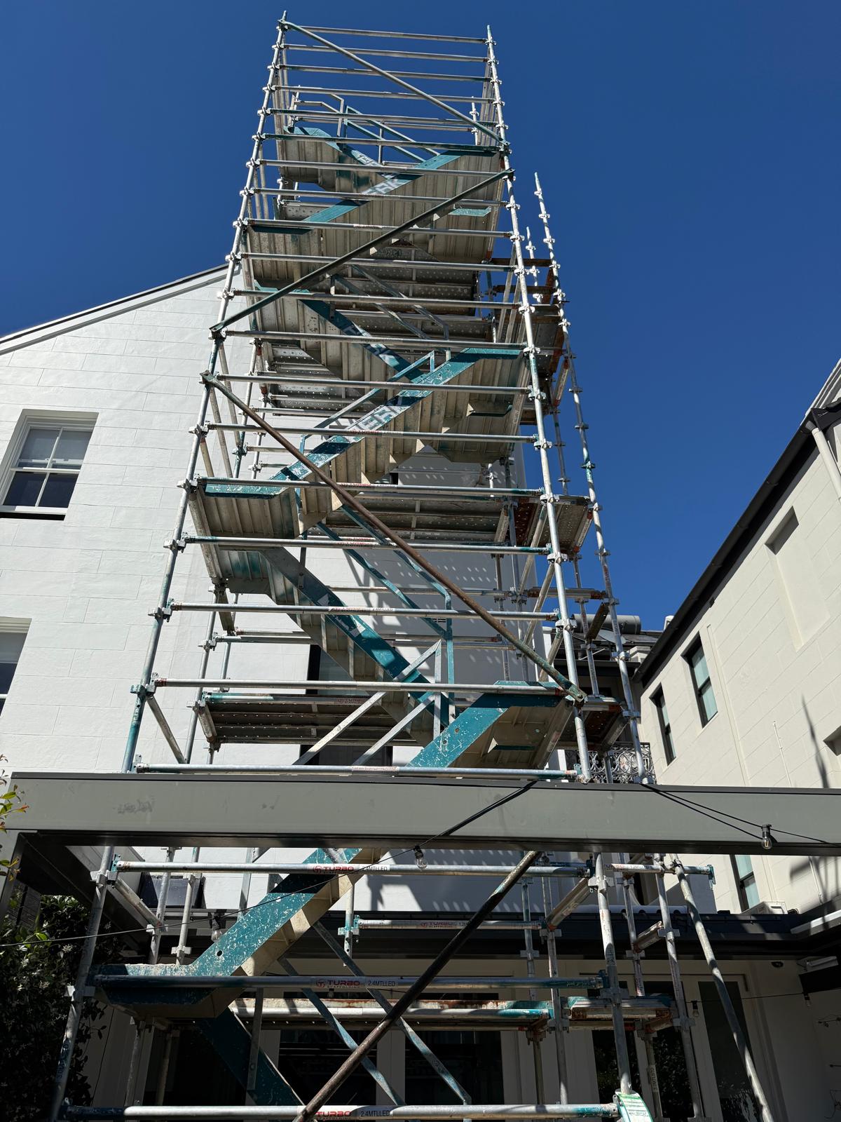 Scaffolding up the side of a two-storey Sydney home during a rear extension